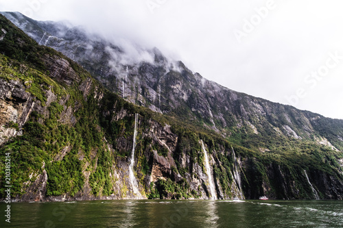 A stunning scene of nature with many waterfalls from the high mountain at Milford Sound  New Zealand.