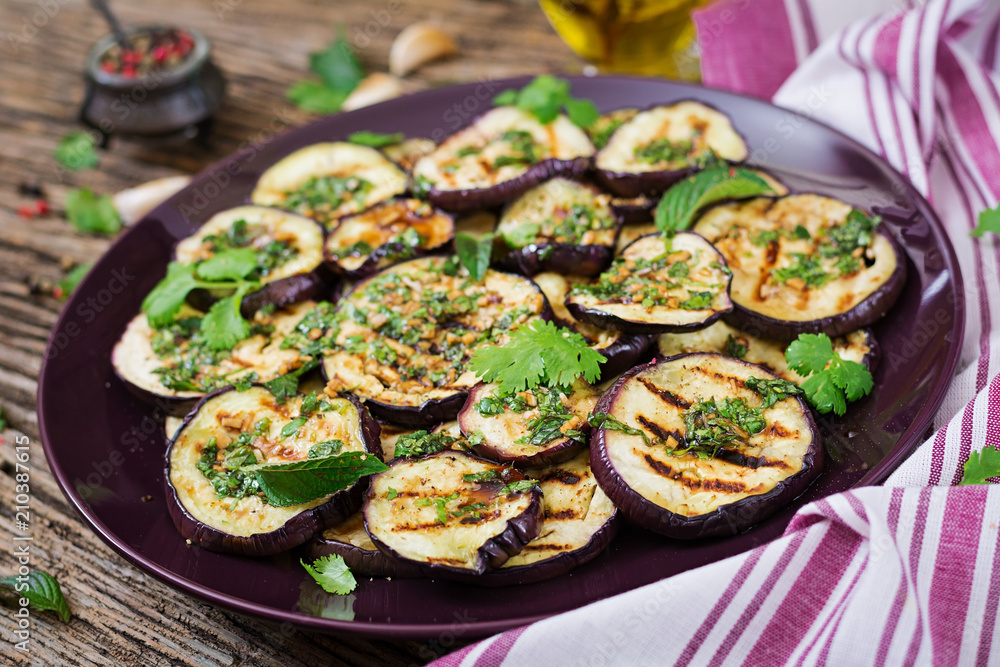 Eggplant grilled with balsamic sauce, garlic, cilantro and mint. Vegan food. Grilled aubergine. Eggplant grilled with balsamic sauce, garlic, cilantro and mint. Vegan food. Grilled aubergine.