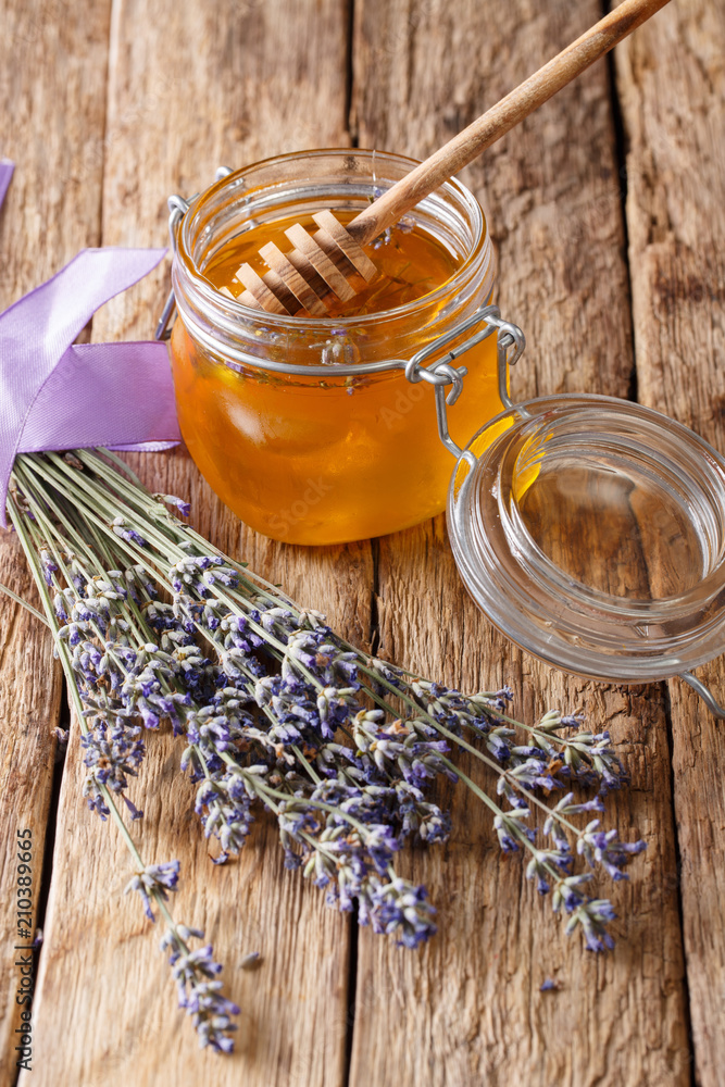 Healthy food: floral lavender honey in a glass jar close-up. vertical Healthy food: floral lavender honey in a glass jar close-up. vertical