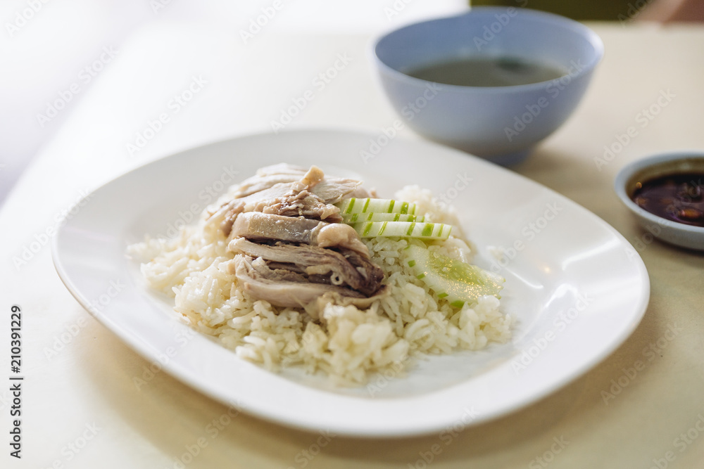 Hainanese chicken rice, Thai gourmet steamed chicken with rice served with sliced of cucumber and soup.