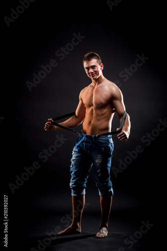 Shirtless man in suspenders © Grafvision