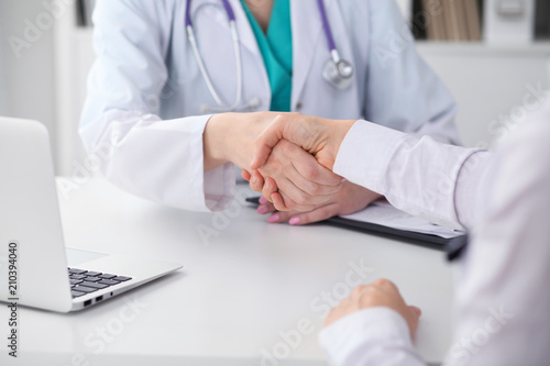 Doctor and patient shaking hands, close-up. Medicine, healthcare and trust concept © rogerphoto