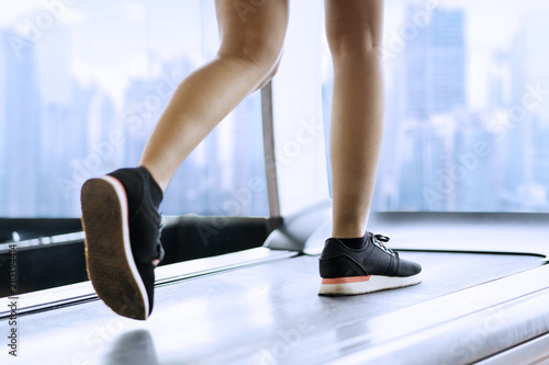 Feet of unknown woman running on the treadmill