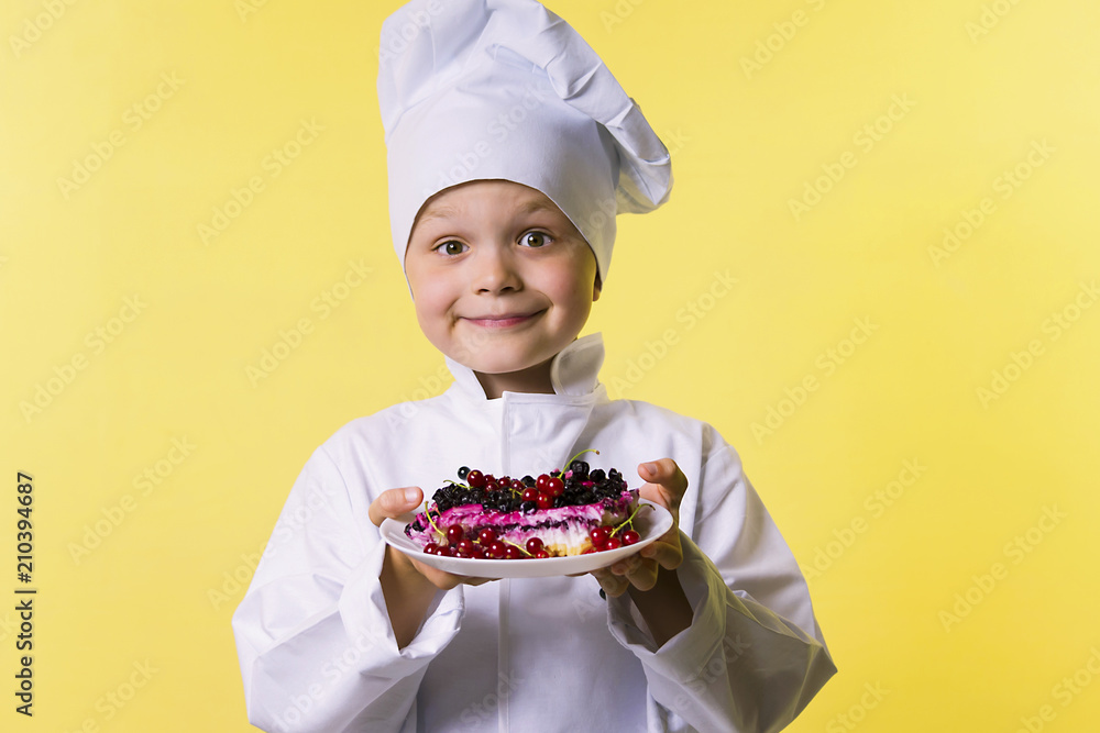 funny boy chef cooked pie with a wig and currant on a plate funny boy chef cooked pie with a wig and currant on a plate