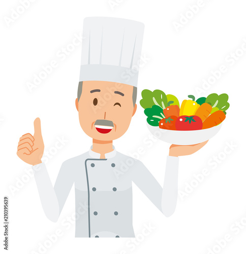 An elderly male chef wearing a cook coat has vegetables