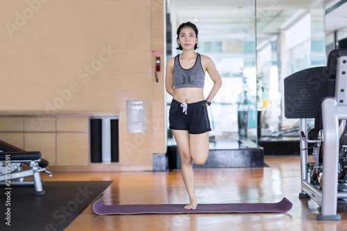 Sporty woman doing a stretch in the fitness center