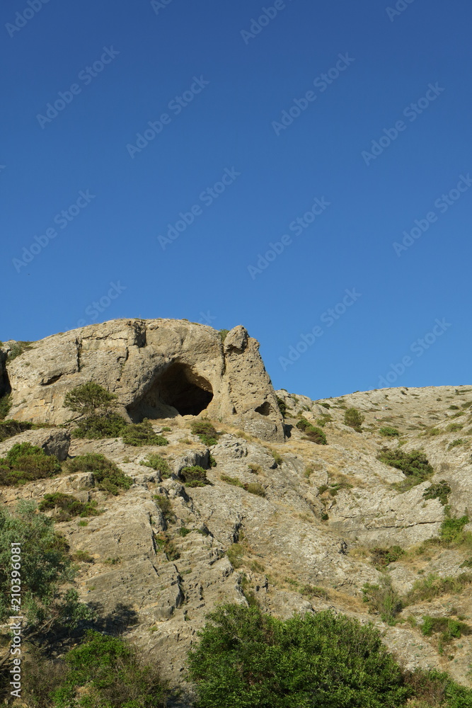 Image of a cave in a rock.
