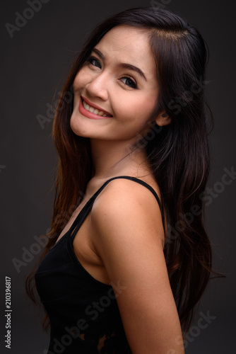 Young beautiful Asian woman smiling