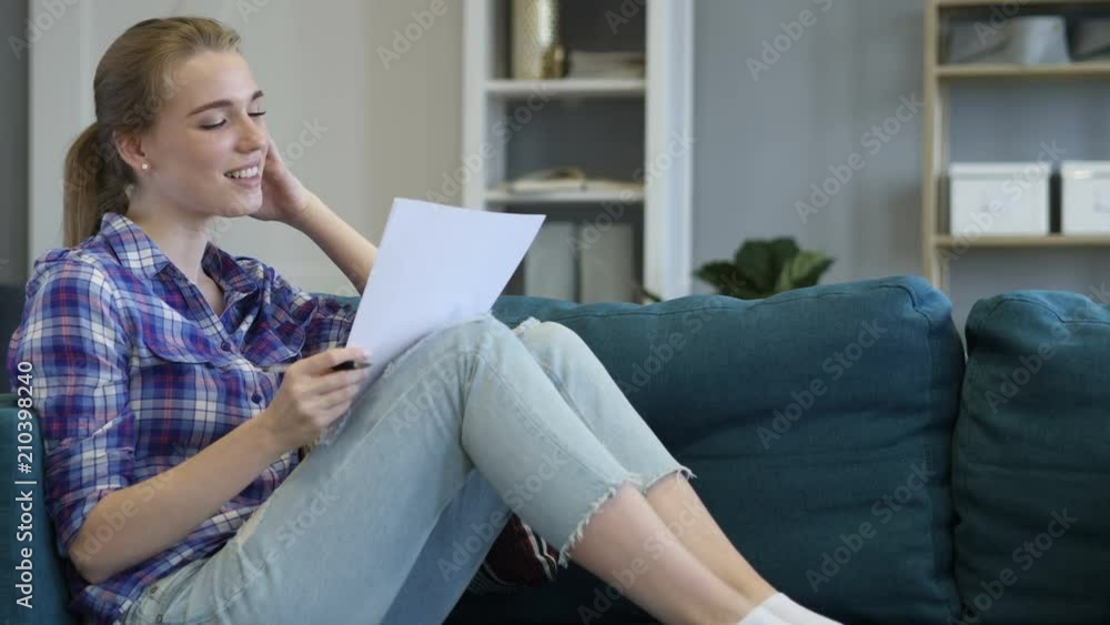 Casual Woman Reading Documents and Looking in Camera Casual Woman Reading Documents and Looking in Camera