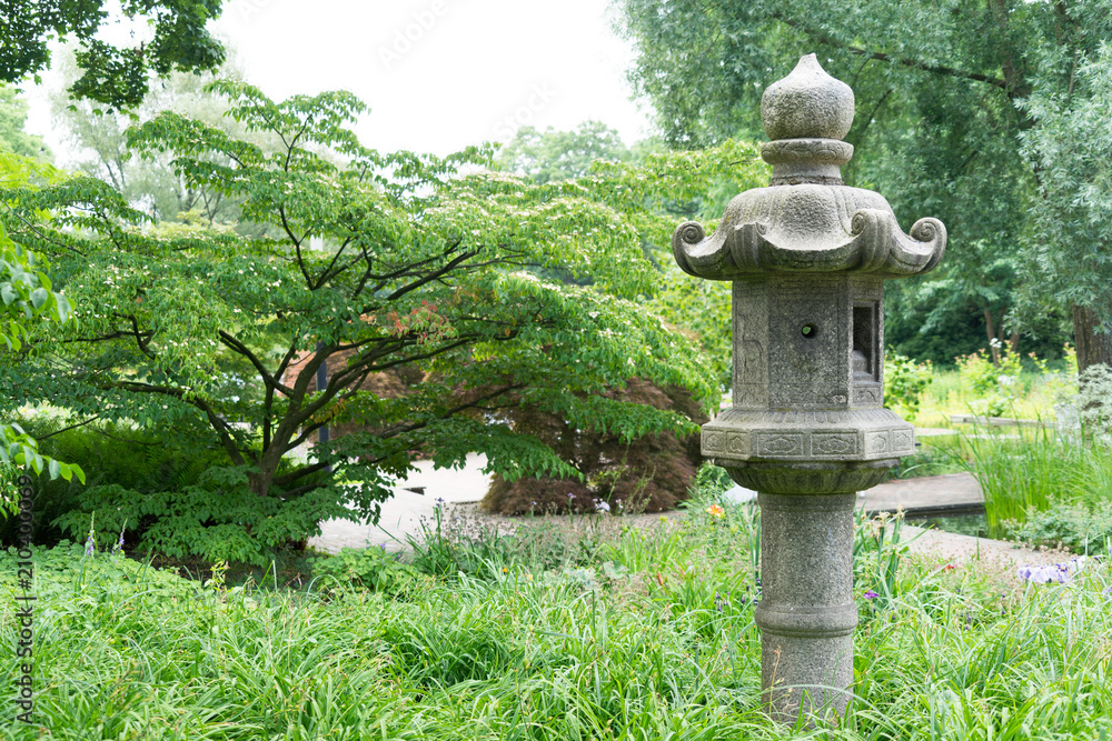 Japanese decorative stone lantern in a green garden