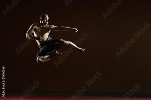 The man beats a kick in the jump to the side © andreyfire