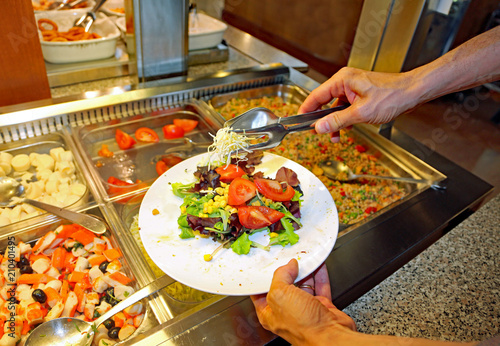 Obraz na plátně customer  serving himself from trays with vegetables