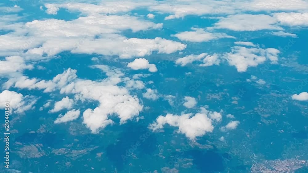 Wonderful view of the sky and clouds from above, as seen through an airplane window. Wonderful view of the sky and clouds from above, as seen through an airplane window.