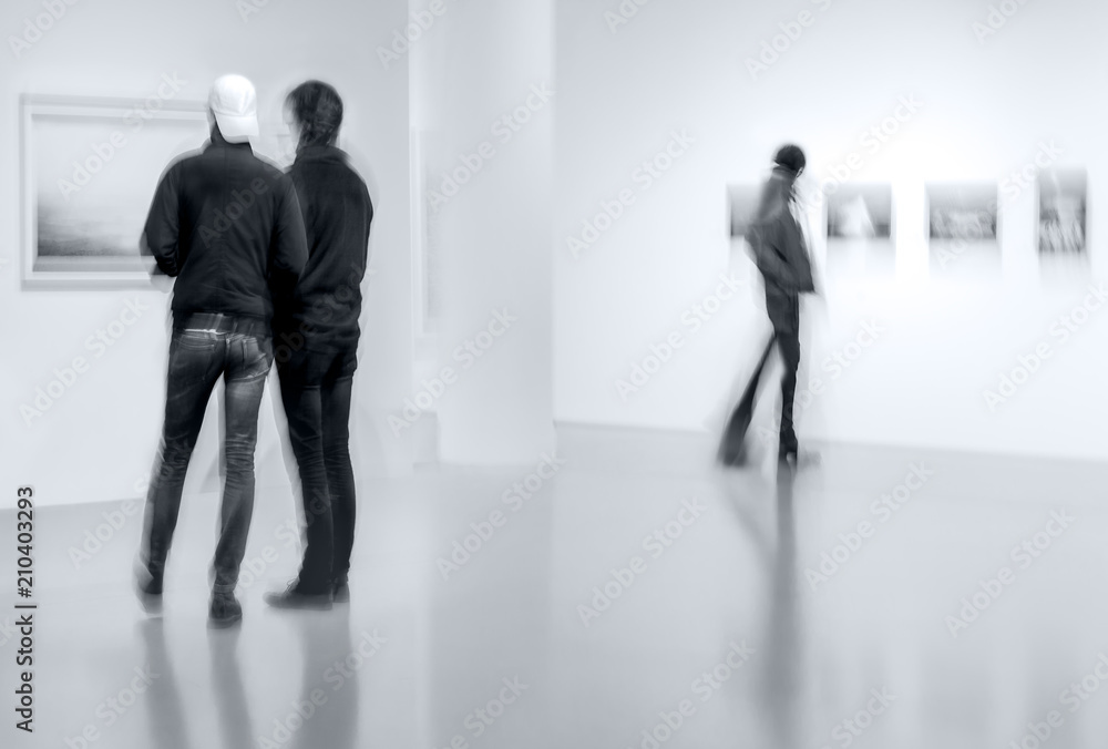 people in the art gallery center in monochrome blue tonality people in the art gallery center in monochrome blue tonality
