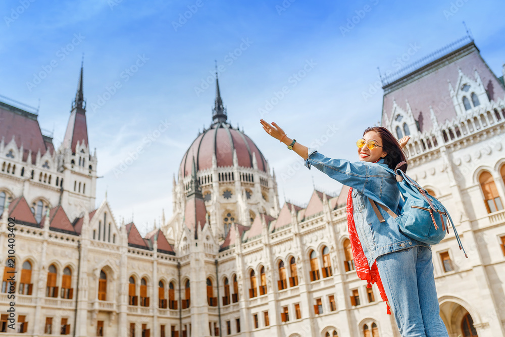 Fototapeta premium Happy asian casual woman student enjoying great view of the Parliament building in Budapest city, travel in Europe concept