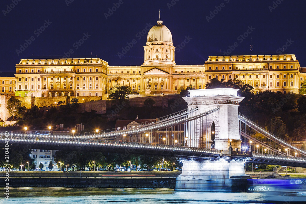 View of Budapest National Gallery and Szechenyi Chain Bridge at night from Danube river