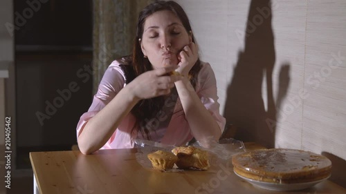 Wallpaper Mural Young woman at night in the kitchen eating a bun. Torontodigital.ca