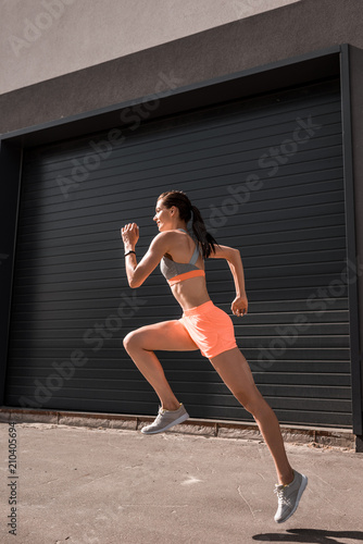 young attractive sportswoman running in sportswear
