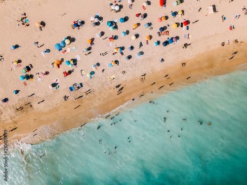 Aerial View From Flying Drone Of People Crowd Relaxing On Algarve Beach In Portugal