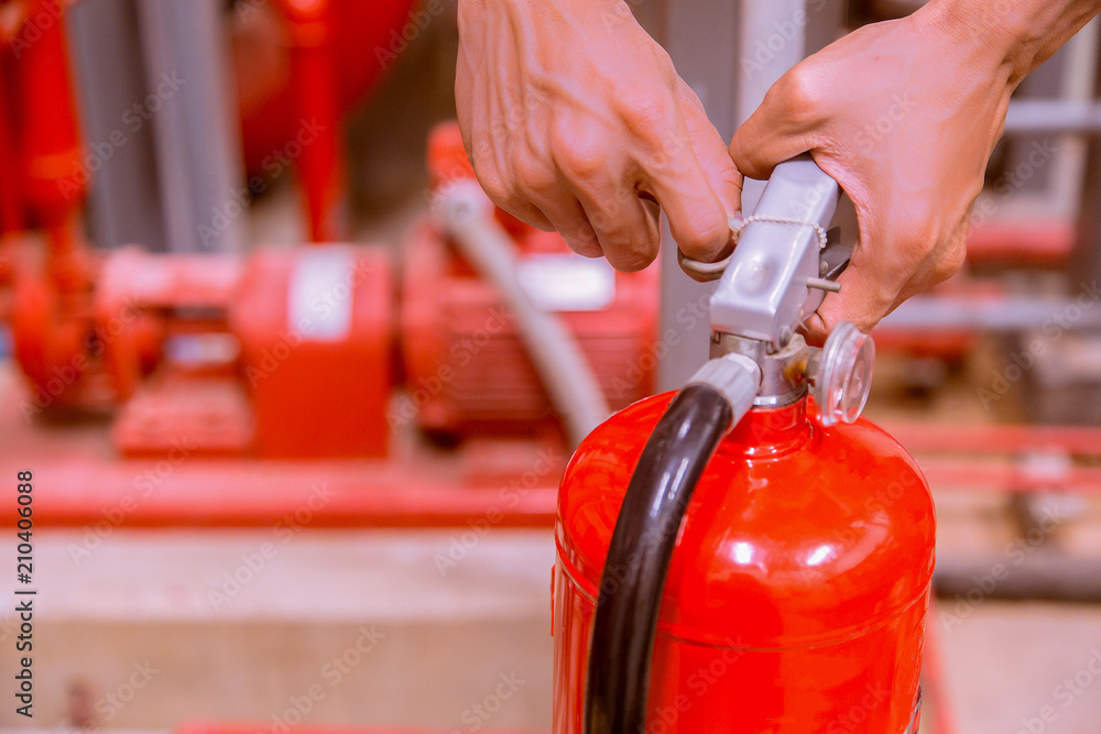 Close up Fire extinguisher and pulling pin on red tank.