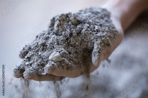 ashes in hands, ashes pour through fingers of hands