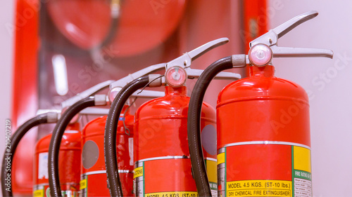 Red tank of fire extinguisher Overview of a powerful industrial fire extinguishing system. photo