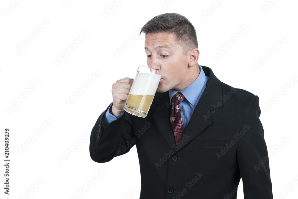 Young businessman in suit drinking beer from mug, isolated on white background Young businessman in suit drinking beer from mug, isolated on white background