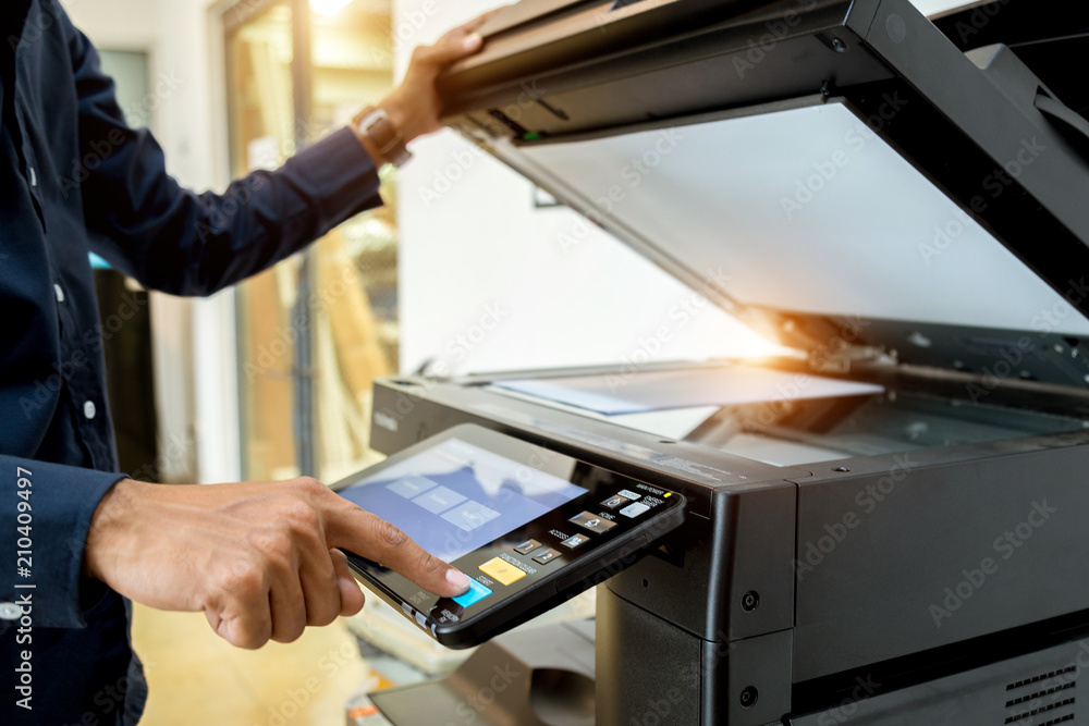 Bussiness man Hand press button on panel of printer, printer scanner laser office copy machine supplies start concept. Bussiness man Hand press button on panel of printer, printer scanner laser office copy machine supplies start concept.