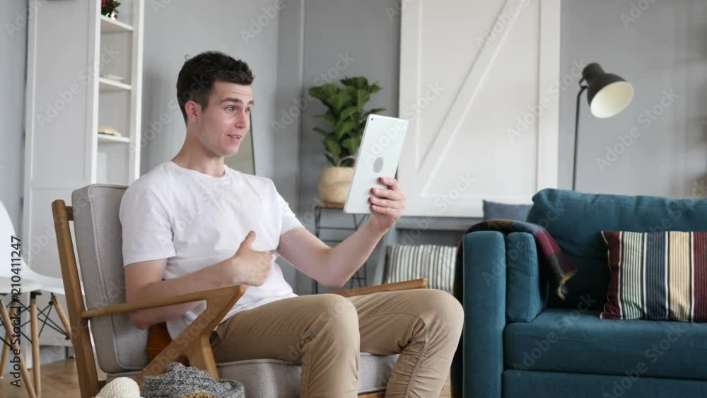 Relaxing Man Talking During Online Video Chat on Tablet Relaxing Man Talking During Online Video Chat on Tablet