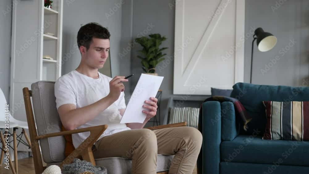 Reading Man Going Through Contract, PaperWork Reading Man Going Through Contract, PaperWork