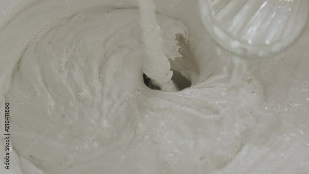 Slow motion closeup adding water into decorative concrete plaster Slow motion closeup adding water into decorative concrete plaster