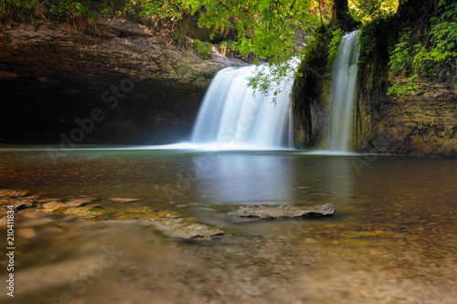 French landscape - Jura. Le Gour Bleu waterfall in the Jura mountains after heavy rain.