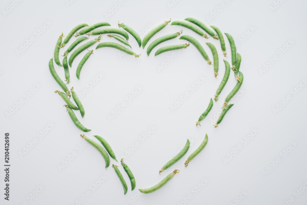 top view of heart made of fresh green peas isolated on white top view of heart made of fresh green peas isolated on white
