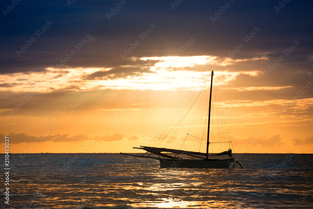 boat sailing illuminated by the sun rays