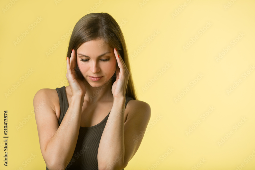 beautiful young girl with flowing hair on a yellow background with a pensive face beautiful young girl with flowing hair on a yellow background with a pensive face