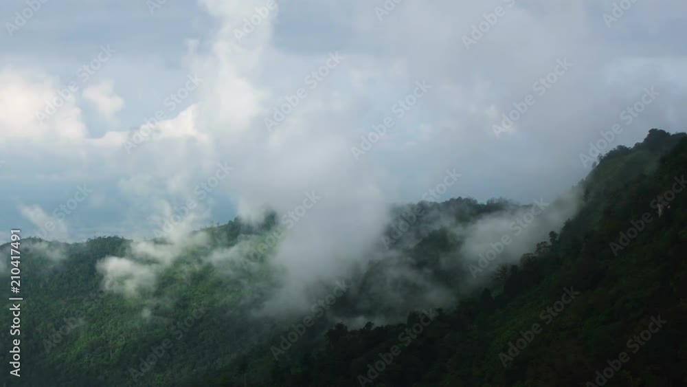 Misty valley and layers of tropical mountain With Wind turbine on top at Phu Hin Rong Kla National Park , Thailand. Misty valley and layers of tropical mountain With Wind turbine on top at Phu Hin Rong Kla National Park , Thailand.