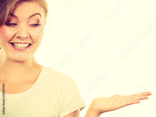 Happy blonde woman presenting with palm hand