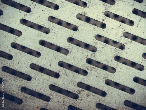 Abstract closeup of steel texture with holes
