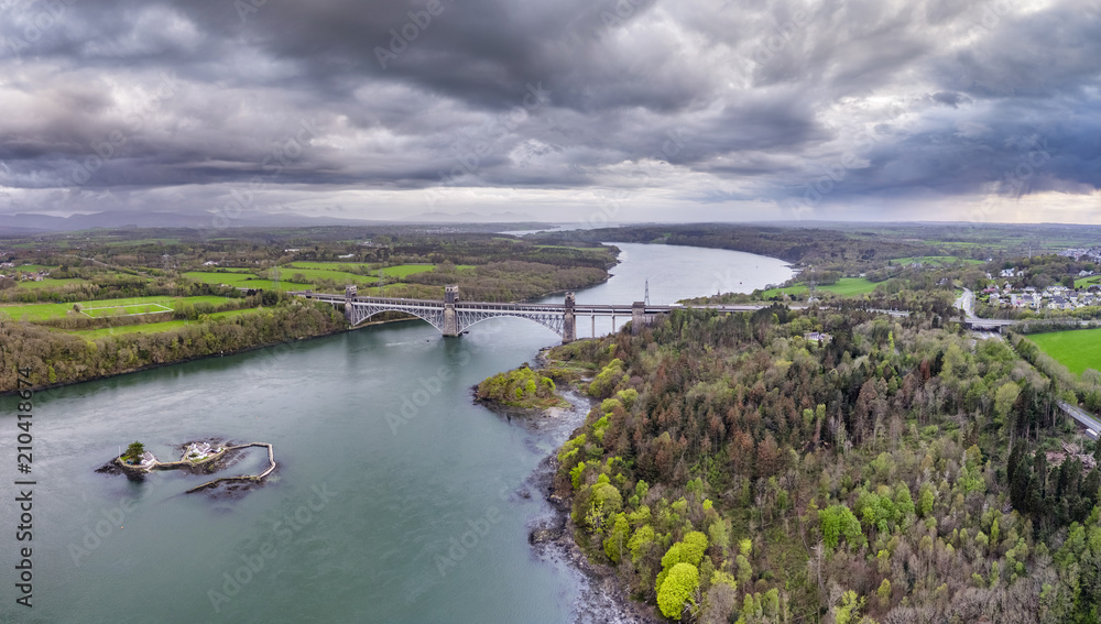 Robert Stephenson Britannia Bridge carries road and railway across the Menai Straits between, Snowdonia and Anglesey Robert Stephenson Britannia Bridge carries road and railway across the Menai Straits between, Snowdonia and Anglesey