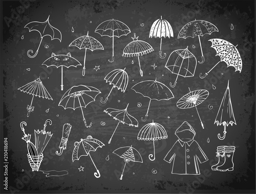 Set of doodle sketch umbrellas on blackboard background