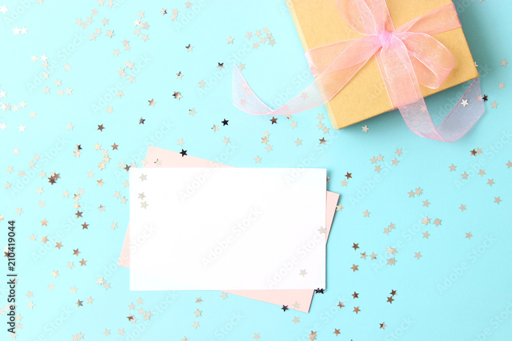 close-up of a gift and a card for text on a colored background top view. holiday, giving, birthday, new year, christmas. close-up of a gift and a card for text on a colored background top view. holiday, giving, birthday, new year, christmas.