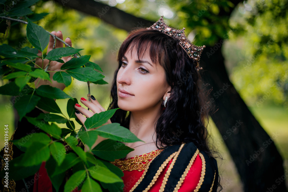 Queen. Beautiful girl in the crown. Fantasy. Medieval black and red dress with gold embroidery. Queen. Beautiful girl in the crown. Fantasy. Medieval black and red dress with gold embroidery.