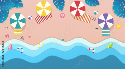 Top view sea, the beach with umbrellas, sun beds and tropical leaves around.