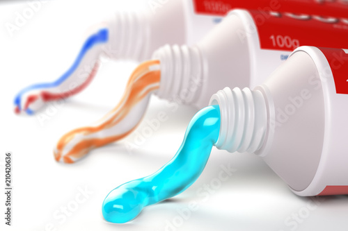 Tubes of toothpaste in different colors and differnt types of toothpaste photo