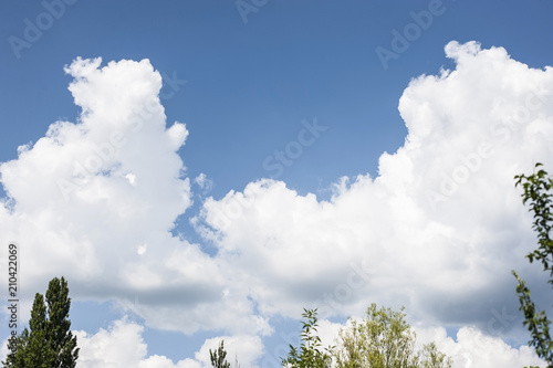 Beautiful white clouds after the rain against the background of a blue clear sky