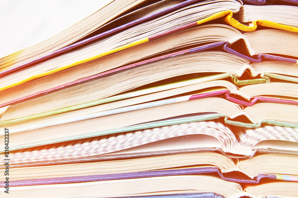 Educational school books lie one on one on a white background. The concept of back to school Educational school books lie one on one on a white background. The concept of back to school