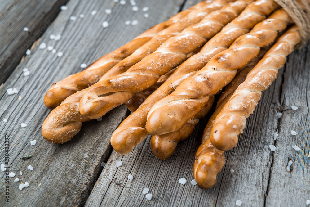 Homemade cheese bread sticks on a light wooden background Homemade cheese bread sticks on a light wooden background