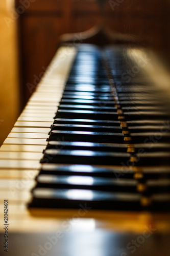 Old piano keyboard. Vertical closeup photo of piano claviature. photo