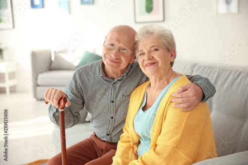 Εκτύπωση καμβά Elderly couple sitting on couch in living room
