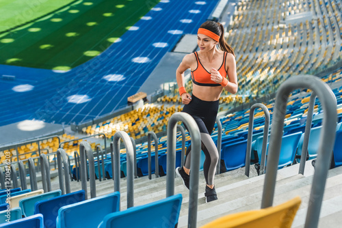 high angle view of beautiful athletic woman jogging upstairs at sports stadium © LIGHTFIELD STUDIOS